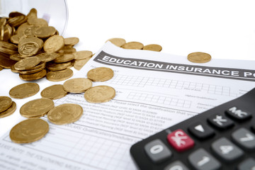Coins with calculator and education insurance form