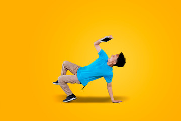 Excited man man break dancing with digital tablet