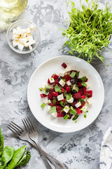Baked beets with feta cheese and shoots of young peas