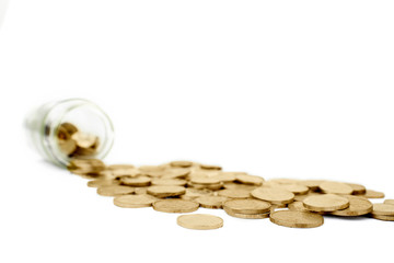 Golden coins and a glass jar in the studio