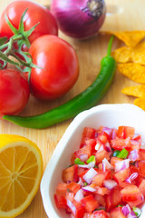 Mexican salsa pico de gallo with tomatoes, red onions, spicy green jalapeno pepper, lemon and nacho corn chips