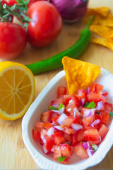 Mexican salsa pico de gallo with tomatoes, red onions, spicy green jalapeno pepper, lemon and nacho corn chips