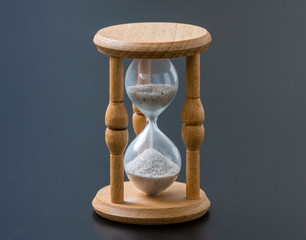 Aged hourglass with flowing sand