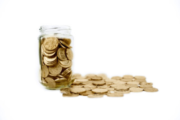 Jar full of golden coins in the studio