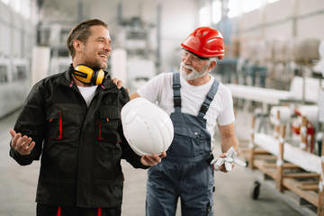 Colleagues working together. Workers in factory.	