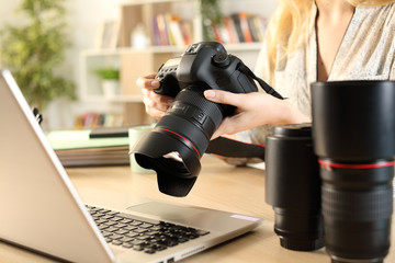 Photographer hands with laptop checking camera