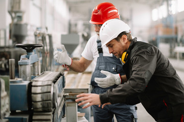 Colleagues working together. Workers in factory.	