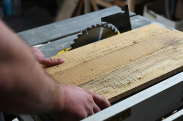 Man cutting wood, close up hands.