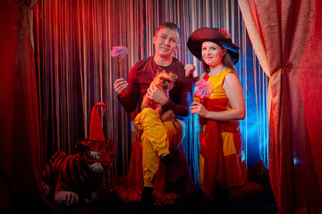 Man and woman with small dor on the theater stage. Photo shoot in the circus style with girl, boy...