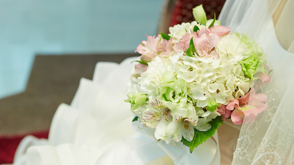 Bride in wedding dress holding flower bouquet 