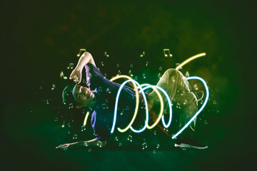 Young man break dancing with light effect