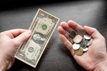 holding a dollar in one hand, in another Russian rubles concept economic crisis