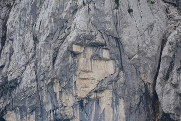 lady face in the stone wall in the mountains