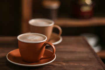 Cup of tasty cappuccino on table in cafe
