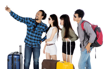 Young tourists taking selfie photo together