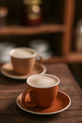 Cup of tasty cappuccino on table in cafe