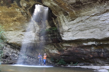 Woman standing in Saeng Chan Waterfall at Pha Taem National Park, Ubon Ratchathani, Thailand