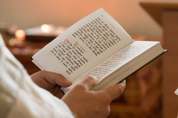 Bible in the hands of a priest