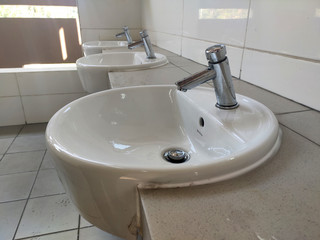 Hand washbasins at the public toilet. Installation complete with face mirror. Made from white glazed ceramic.
