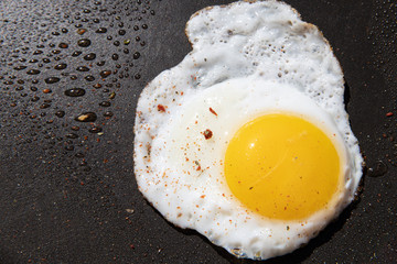 Scrambled egg on black pan background