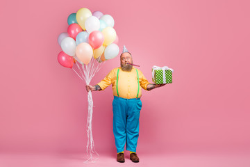 Full length body size view of his he nice funky bearded guy holding in hands bunch air ball giftbox whistling single alone lonely party time isolated over pink pastel color background - obrazy, fototapety, plakaty