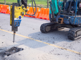 Road works  building site excavator and worker