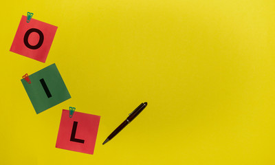OILinscription on red and green stickers and pen on yellow background. Oil WTI concept