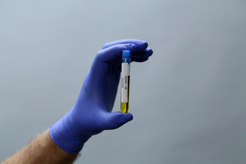 Doctor holds COVID 19 Coronavirus vaccine in his hand