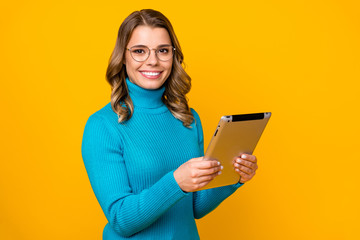 Fototapeta premium Photo of beautiful attractive wavy business lady hold modern technology e-reader corporate report online email wear specs blue turtleneck isolated bright yellow color background
