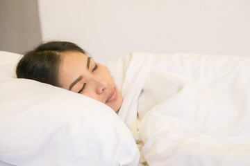 Fototapeta na wymiar Beautiful woman sleeping on white pillow