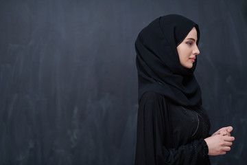 portrait of beautiful muslim woman in front of black chalkboard