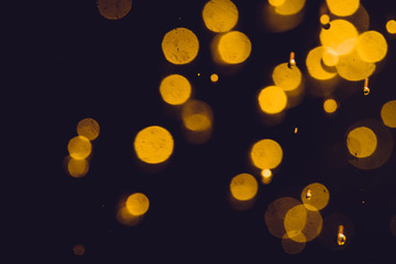 Dark Abstract Gold bokeh sparkle on black background