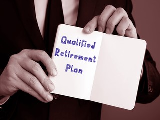 The photo says Qualified Retirement Plan. Notepad, pen, marker.