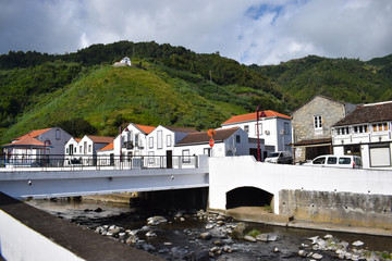 Fototapeta na wymiar Empty streets in Portugal due to coronavirus. Azorean islands, small town with white houses by the river