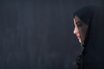 portrait of beautiful muslim woman in front of black chalkboard