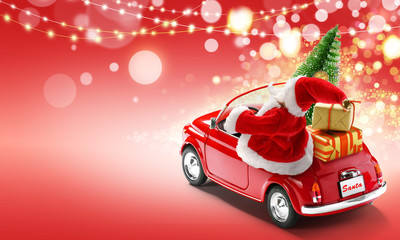 Santa Claus driving red car with gift boxes and Christmas tree on red background with bokeh lights