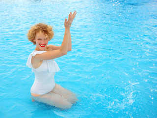 beautiful smiling redhead (ginger) woman portrait enjoying life in the swimming pool in the summer day. Summer, relax, wellness, travel, recreation concept