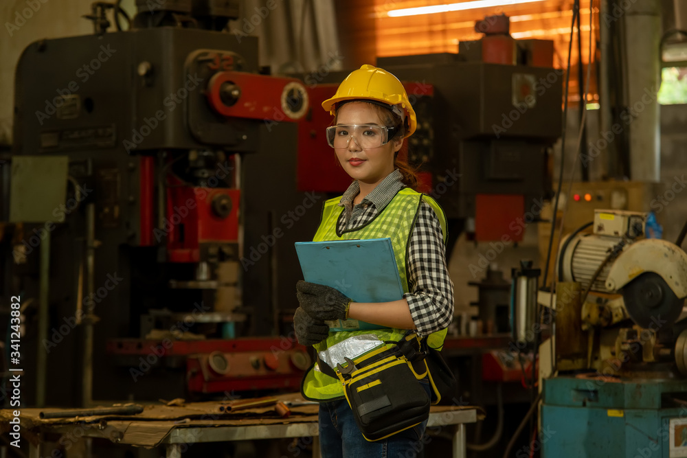Poster Portrait of a worker in the helmet working at factory with Various Metalworking Processes,Industrial background.