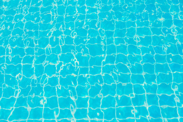 Reflections from the water in the blue swimming pool