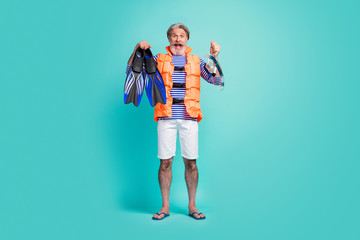 Full body photo of funny aged seaman underwater breathing equipment flippers tube mask diver wear striped sailor shirt shorts orange life vest flip-flops isolated teal color background