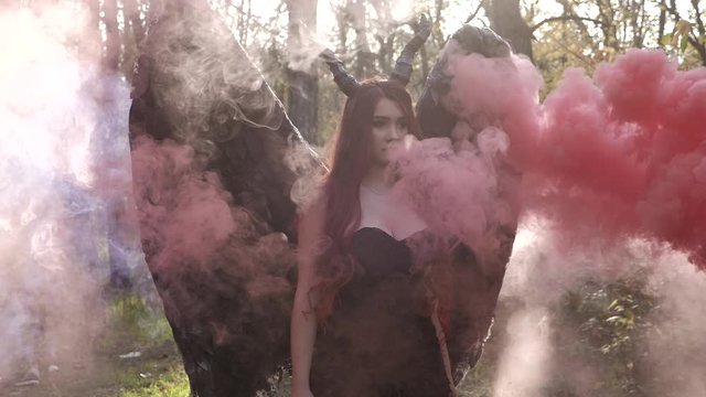 Young beautiful innocent brunette girl walking in the forest