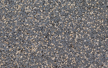 Pebble stones background, dark gravel texture close up