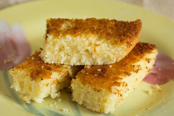 Pieces of baked mannik semolina casserole on yellow plate