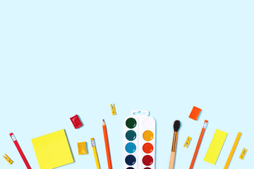 School supplies on blue background. Back to school flat lay picture.