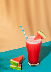 Fresh watermelon smoothie on colorful background
