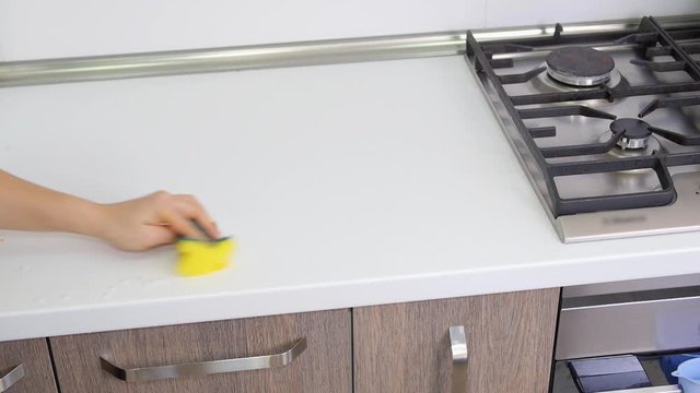 Girl Is Cleaning Kitchen Countertop. Wipe Counters Down On A Kitchen.