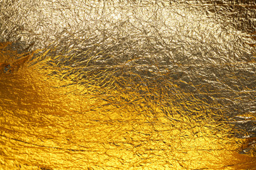 Texture of a thin crumpled sheet of foil. Crumpled foil background. Stock photo foil. Gold chrome...