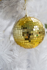 Golden Ball on White Christmas Tree