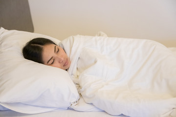 Beautiful woman sleeping on white pillow