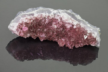 light ruby in geode on grey background
